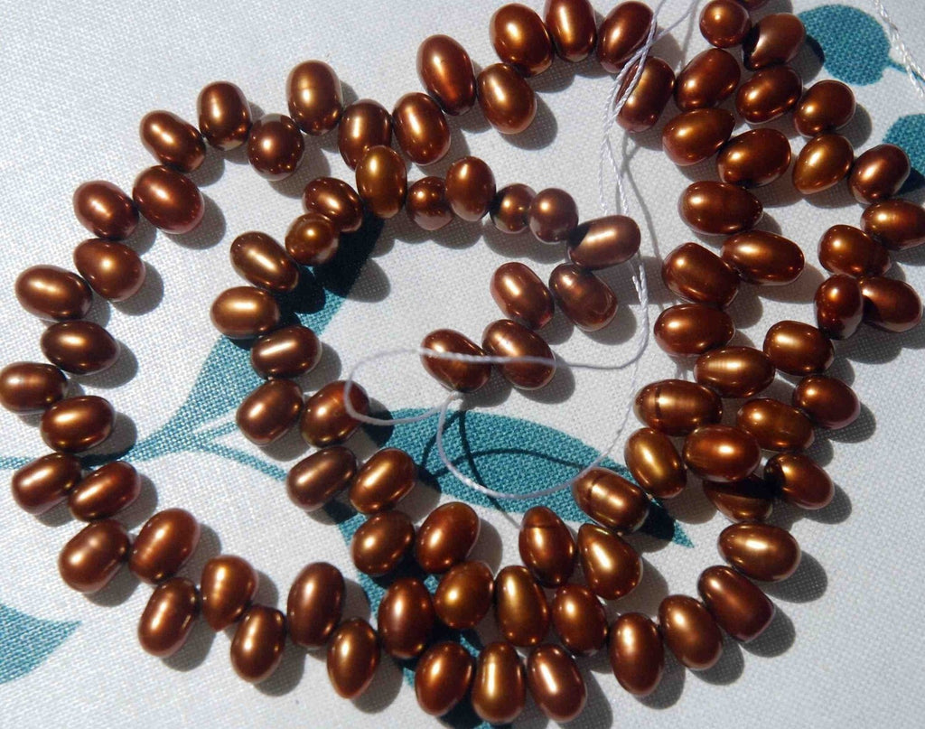 1 full strand AAA Gem quality 5X7mm dancing pearl------85 plus pieces chocolate color rice pearls-------Promotion