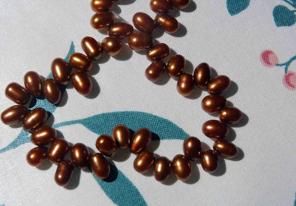 1 full strand AAA Gem quality 5X7mm dancing pearl------85 plus pieces chocolate color rice pearls-------Promotion