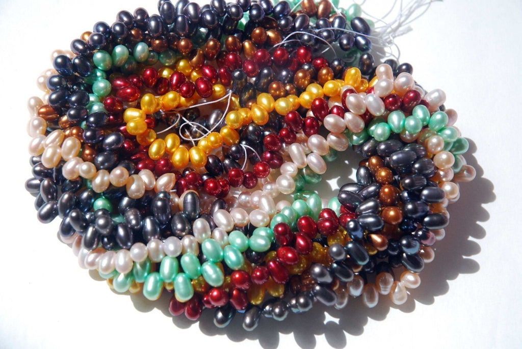 1 full strand AAA Gem quality 5X7mm dancing pearl------85 plus pieces chocolate color rice pearls-------Promotion